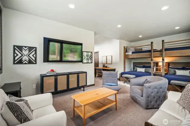 What kid wouldn't love this room?  Bunk beds, TV or Video Game Playing area, sofa, chairs, and their own bathroom.  It's a kids paradise.