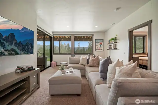 Head downstairs and you find another gathering area that leads out to a covered patio and a few steps from the hot tub - anyone want a soak?