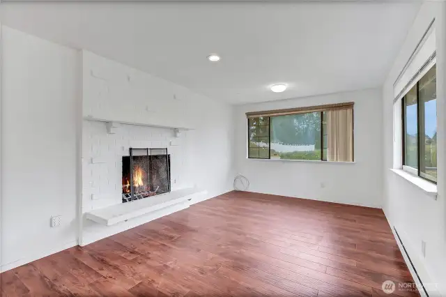 Family room with wood burning fireplace.