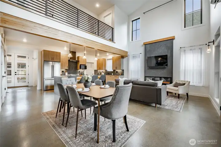 Soaring ceiling with ceiling fan and transom windows.