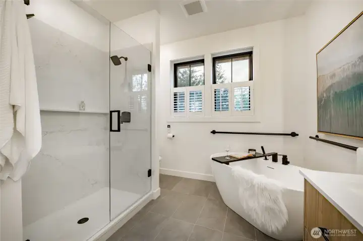 Glass shower doors with dual shower controls.