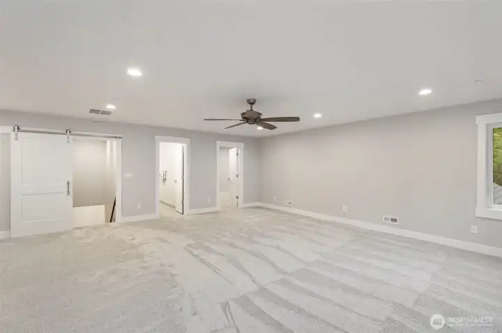 Recreation room looking back at upstairs bath and bonus room.