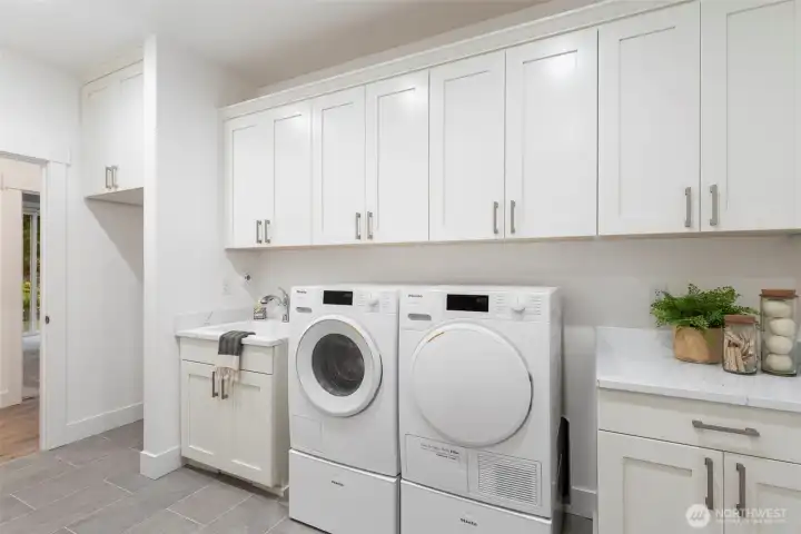 Large laundry room with deep sink and room for fridge.