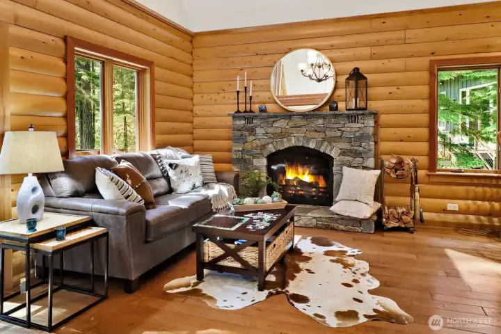 Cozy up to your Rumford-style stone wood fireplace and windows to see the evergreens year around
