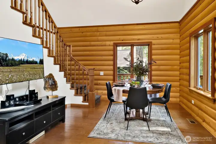 Handcrafted hardwood stair railings and windows with an amazing view at your dining table