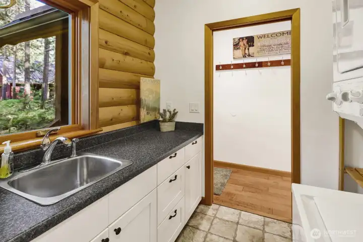 Utility room off of back door with an attached half bath.