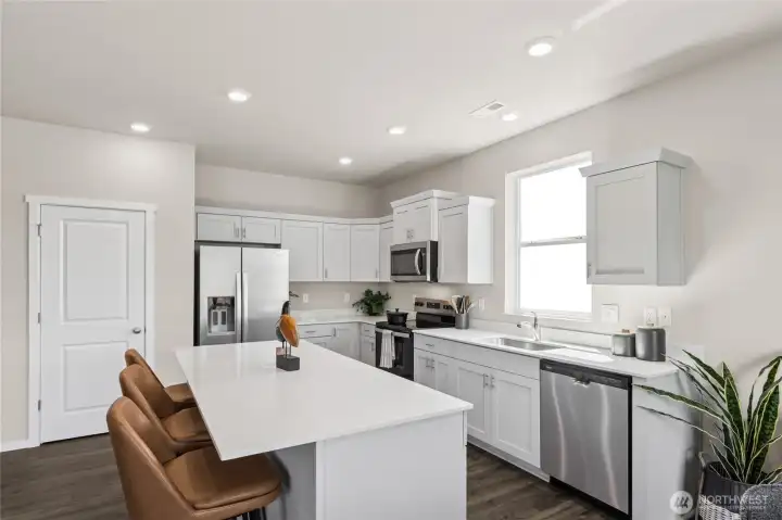 Deep undermount sink and included stainless-steel dishwasher in kitchen makes dishes a breeze. Actual home is under construction. Colors, materials, and features may vary. See site agent for details.