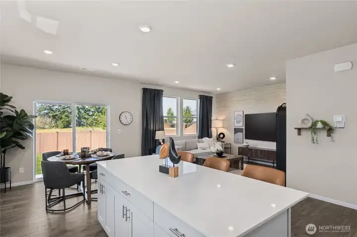 Open concept with kitchen flowing to dining, flowing to great room keeps everyone together. Actual home is under construction. Colors, materials, and features may vary. See site agent for details.