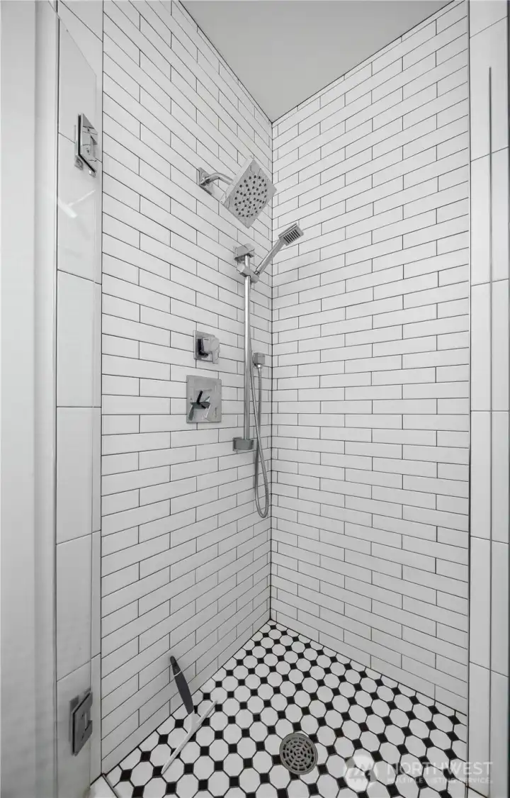 Right down the hallway is the guest restroom with large walk in shower.