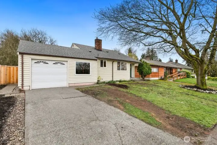 ample driveway leads to oversized single car garage