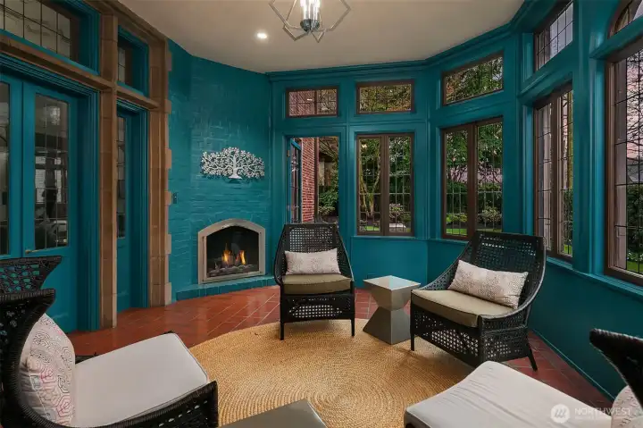 The sitting room, complete with a gas fireplace, is located off the living room.