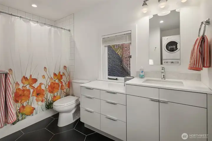 The full bathroom on the top level of the home.The room has heated floors as well as one of the homes 3 laundry facilities.