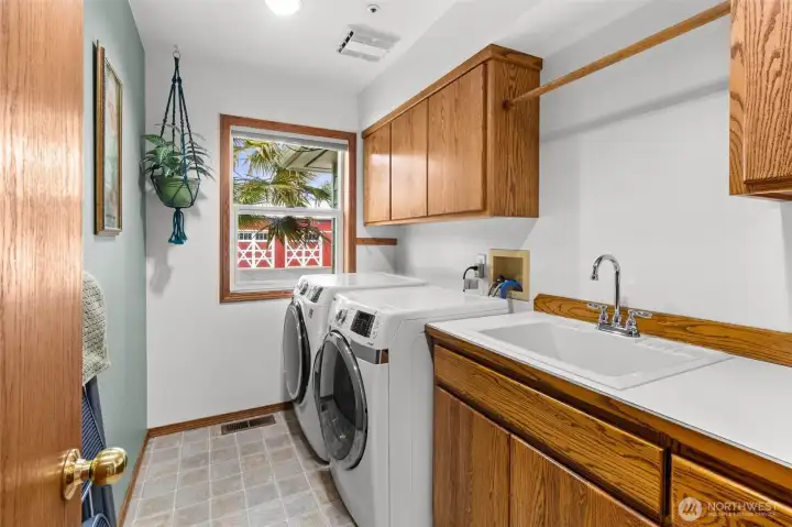 Large utility room with sink and storage