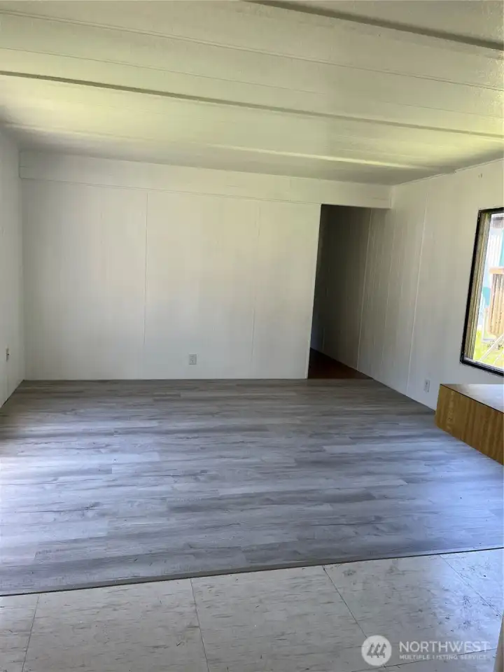 Welcome in. New flooring in living area.