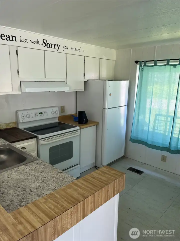 Nice cozy kitchen with room for dining table.