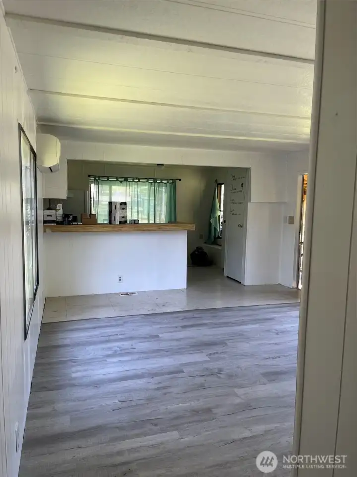 From hallway looking towards living/kitchen. Door to outside barely visible.