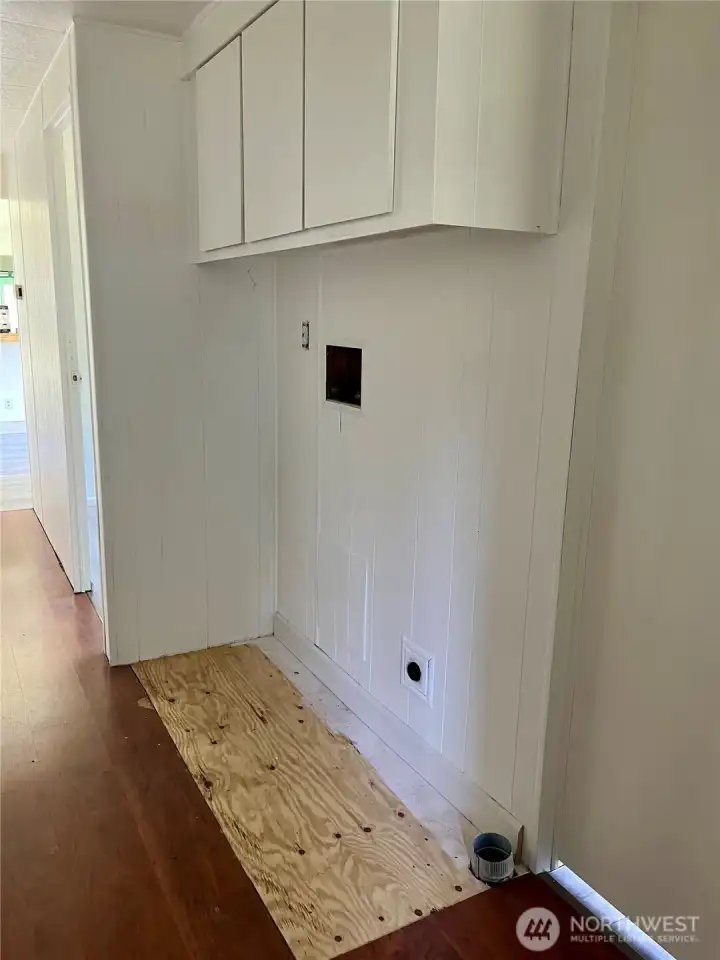 Area for your washer and dryer with storage space above