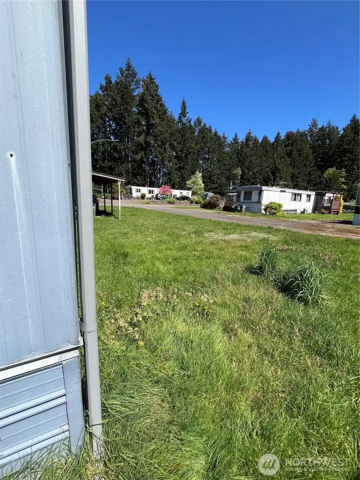 From the back corner of the home looking north across the big yard