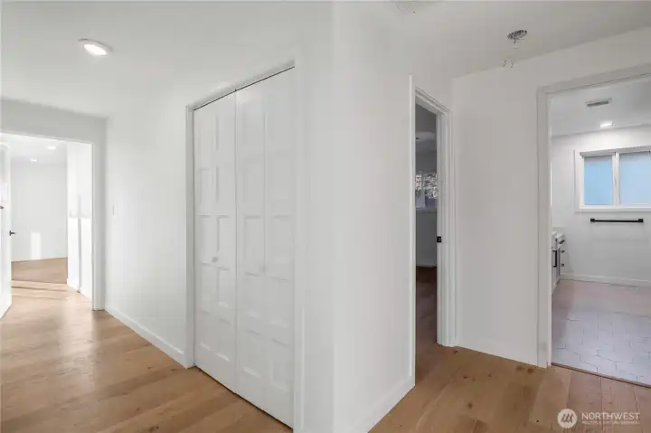 Hallway leading to bedrooms with updated flooring and clean, modern finishes throughout