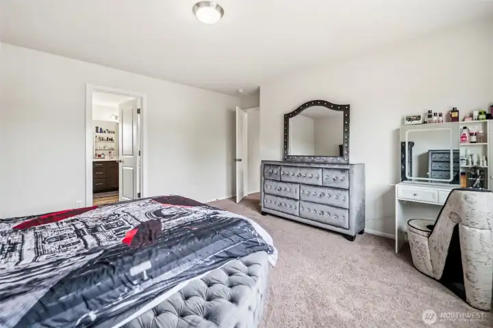 The primary bedroom connects to a private en-suite bath and offers ample space for furnishings.