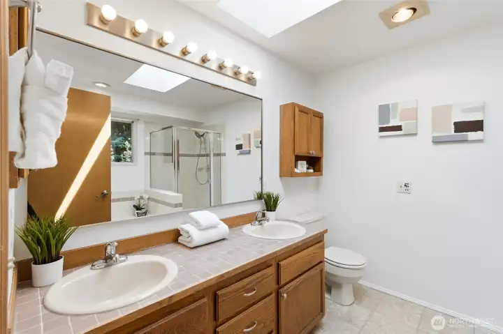 Dual sinks, new light fixture & mirror in primary bathroom.