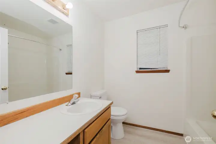 Main bath with new toilet and flooring Main bath with new toilet and flooring
