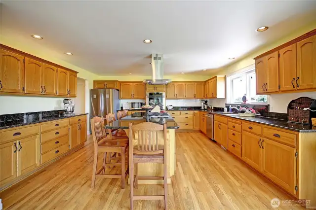 Chef's kitchen with 5 burner Wolf gas cooktop...