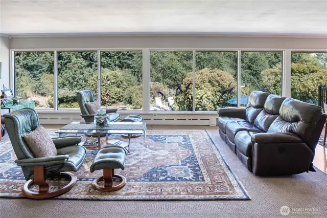 Floor to ceiling wall of windows welcomes you home and offers beautiful year-round views of your private backyard gardens.