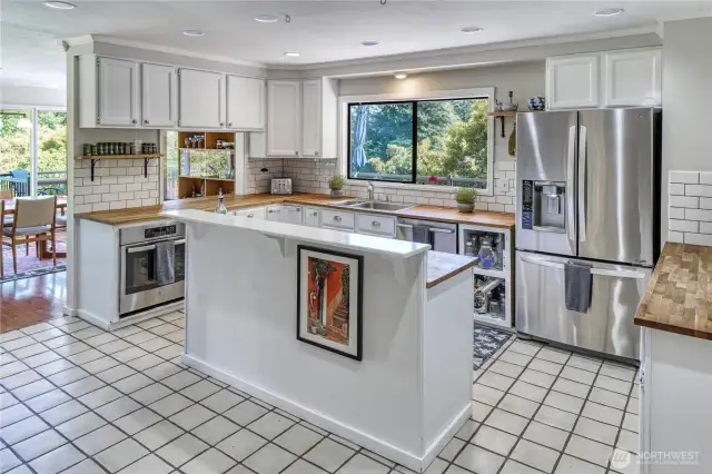 Tile floors and backsplash, butcher block counters, new SS appliances plus a window with a view! What more do you need out of a kitchen?