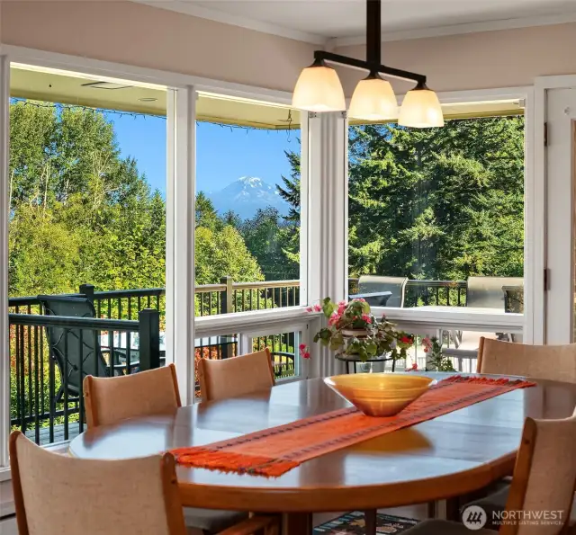 Pastoral views of Mount Rainier framed perfectly by the evergreen and deciduous trees from the dining table and cedar deck.