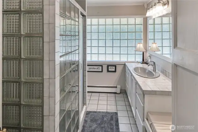 Main level guest bathroom with massive amounts of storage. The glass blocks allow for additional lighting while keeping your privacy.