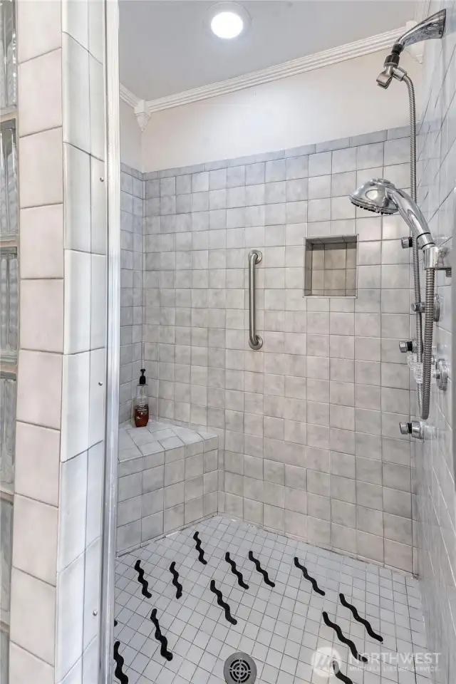 Roomy guest bathroom shower with bench for those days when you need to relax.