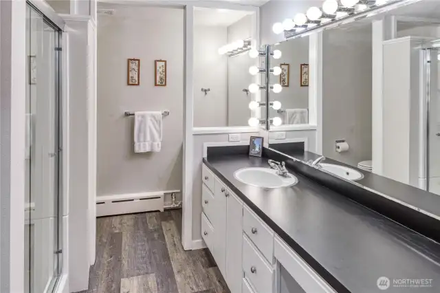 The downstairs bathroom has oodles of counter space and storage, dual sinks and a shower.
