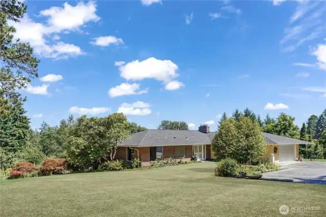 The attached two-car garage has two work benches, storage, and laundry plus there is still room for your two cars! Additional paved parking for your guests or RV. Not pictured is the detached one-car garage.