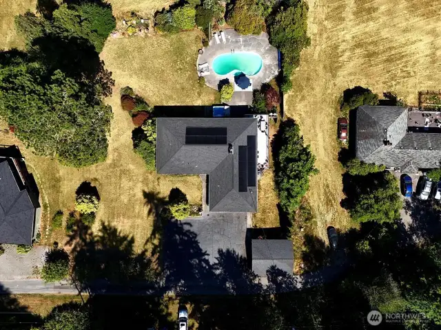 A bird's-eye view of the property. There is a pretty glen on the other side of the rhododendron hedge. Newly installed solar panels keep your power bills to a minimum.