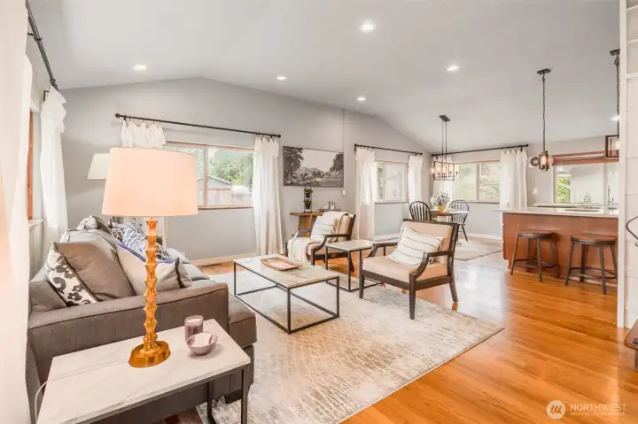 From the front entry you are greeted by an incredible spacious front room with vaulted ceilings, recessed lights, and beautiful white oak hardwood floors--flooded with natural lighting!