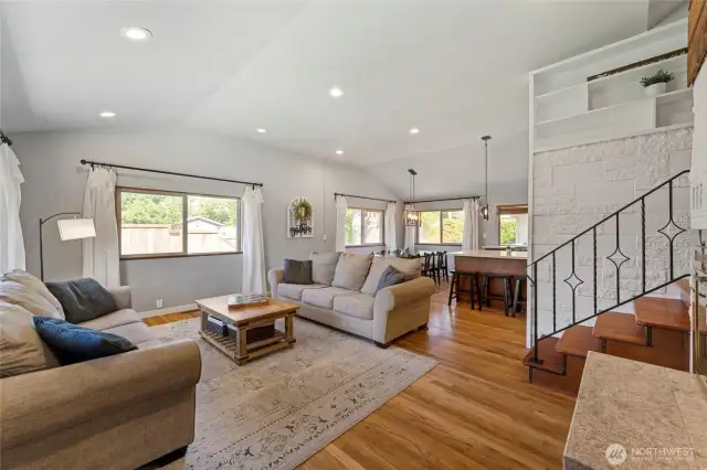 From the front entry you are greeted by an incredible spacious front room with vaulted ceilings, recessed lights, and beautiful white oak hardwood floors--flooded with natural lighting!