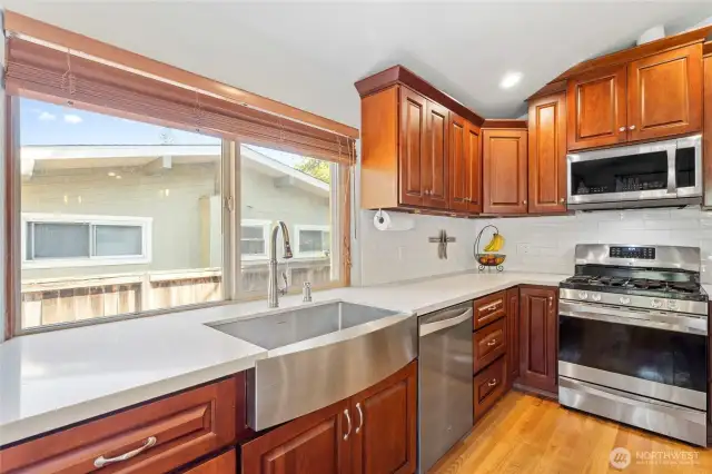 Beautiful cabinetry is accented with quartz and stainless steel...