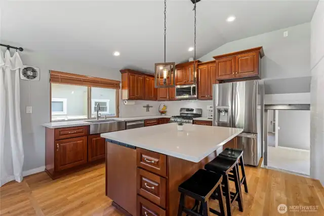 The stairs on the right lead to the lower level -- Utility/Pantry, Family Room, bedroom and full bathroom...or possible multi-generational space?