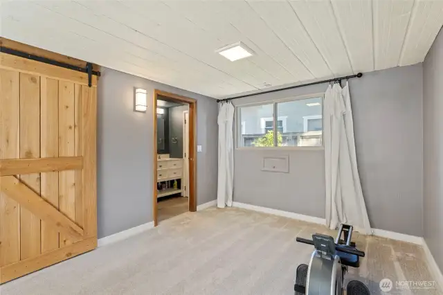 Past the barn doors is the lower level full bathroom...
