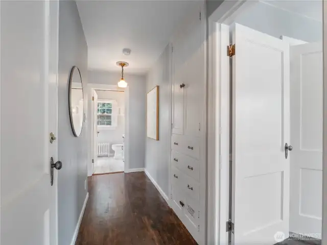 Hallway to basement, primary and hallway bath