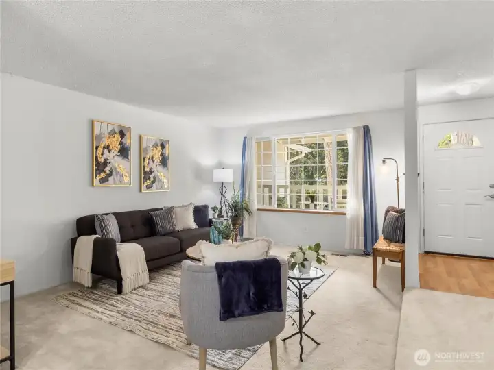 Living room with large window looking out at front yard.