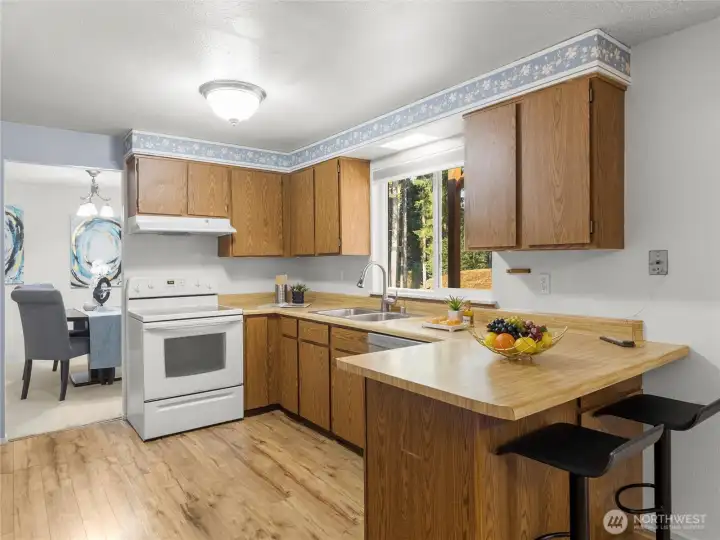 Kitchen connecting to entertainment and dining room.