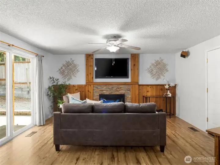 Spacious entertainment space with gas fireplace.