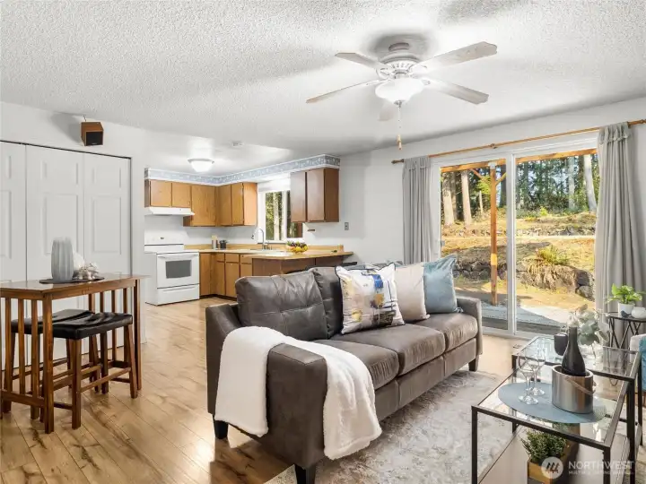 Kitchen overlooking entertainment space and window to view yard.