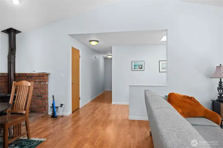 Hallway to bedrooms. First door on right leads to laundry area and then garage.