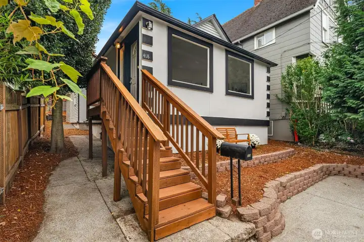 Side yard leads to backyard and storage under the house.