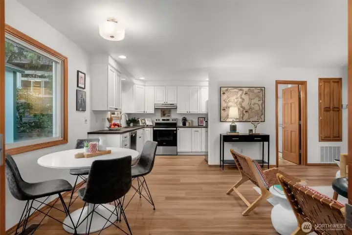 New flooring, counters & appliances in this refreshed open concept kitchen/dining/living room.