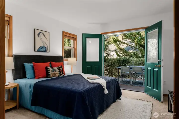 Large primary bedroom with French doors to the deck.