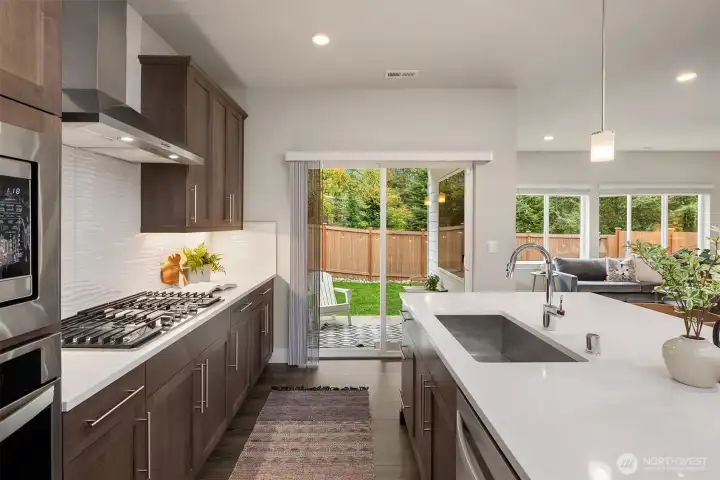 The kitchen flows seamlessly to the covered outdoor patio, ideal for year-round entertaining / grilling.